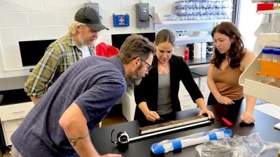 team of researchers measures soil sample on table