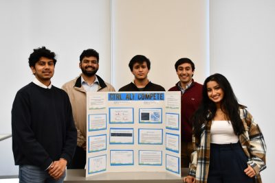 Five students stand with their posterboard created for data competition.