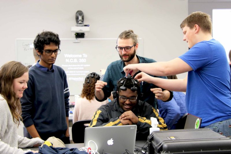 Matthew Emanuel is fitted with an EEG headset to play Pong, 