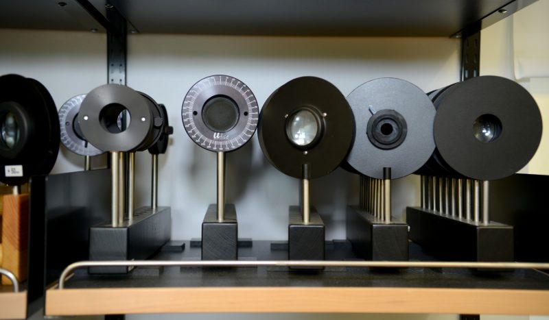 rows of microscope lenses on shelf