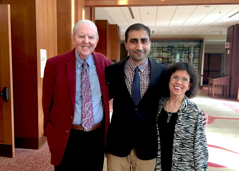 Bill and Sophia Starnes stand with arms around Assad Khan at the Inn at Virginia Tech