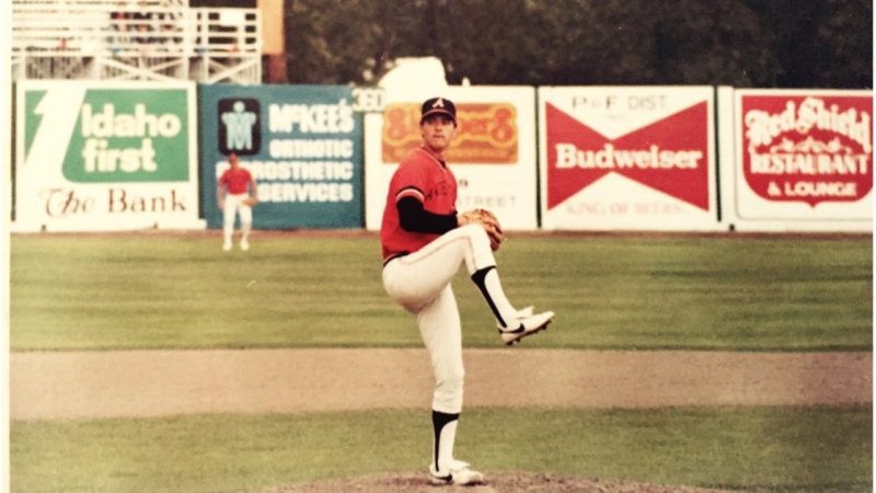 Young Pitts in red jersey throwing a pitch.