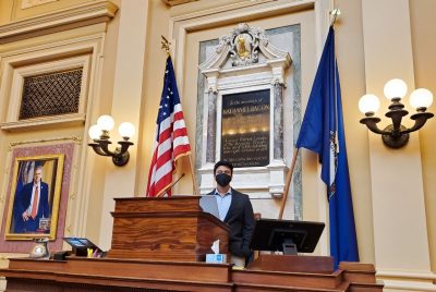 man stands behind podium in the Capitol building