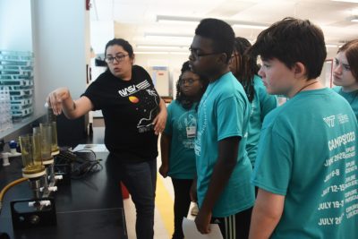 group looks on to chemistry demonstration