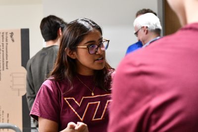 Close shot of student talking to small group.