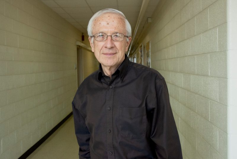 Davis Jenkins with receding, cinderblock hallway