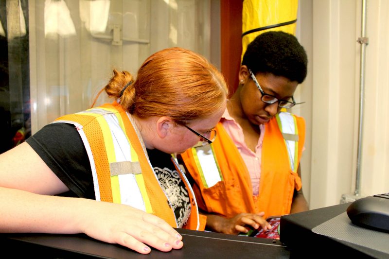 Two female students with caution vests during Department of Physics research experience program