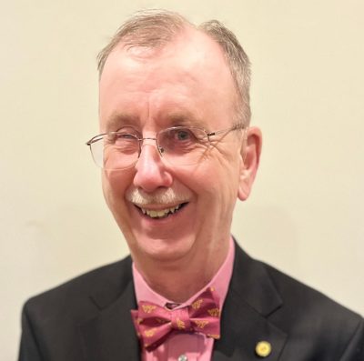 portrait of older man with glasses and bowtie