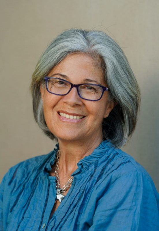portrait of woman with short, gray hair and glasses