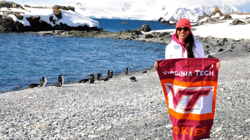 student with VT flag studying in antarctica