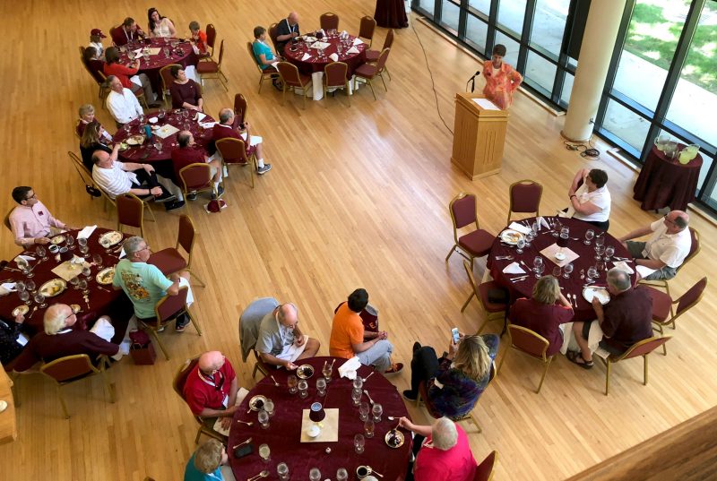 bird's eye view of alumni eating lunch at round tables