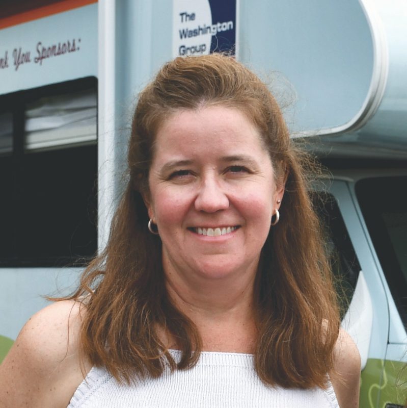 Jen Scott Scott smiles in front of clinic RV