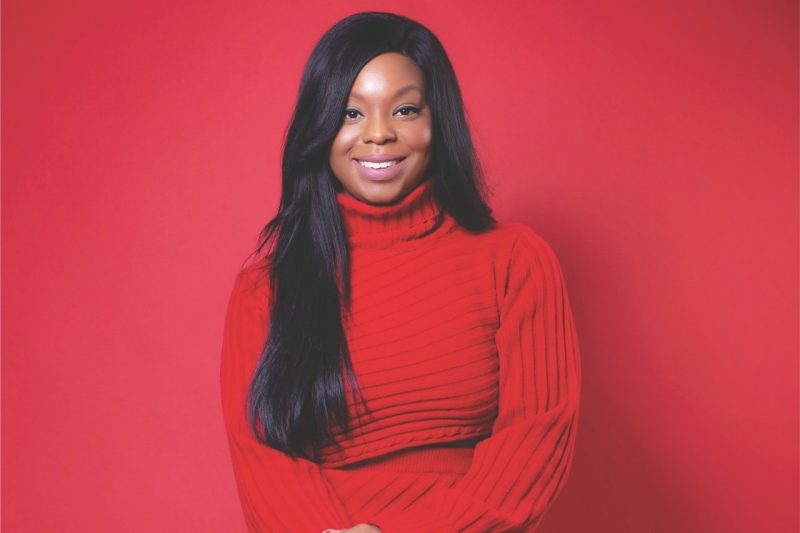 Sofiat in a red turtleneck on a red background.