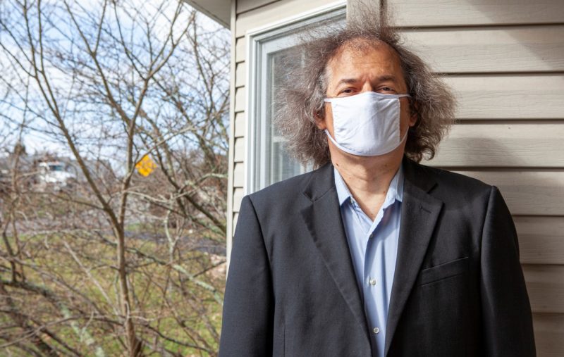Djordje Minic at his home, wearing a mask in accordance to COVID standards and a sports coat.. Photo by Joy Rosenthal.